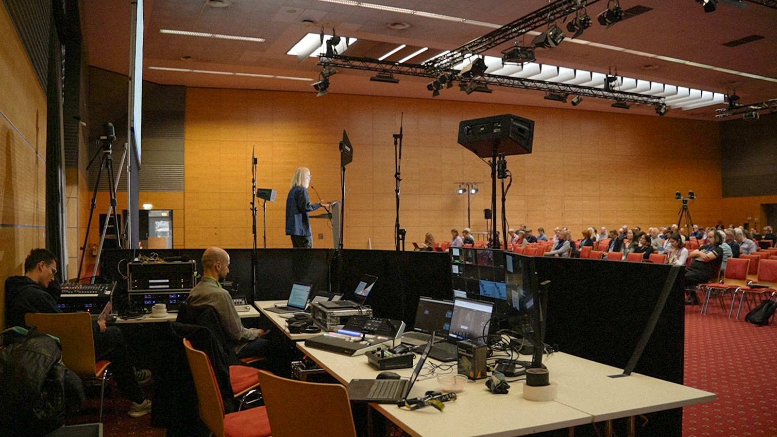 The broadcast desk at a CLARIN conference: switcher, monitors and the room beyond